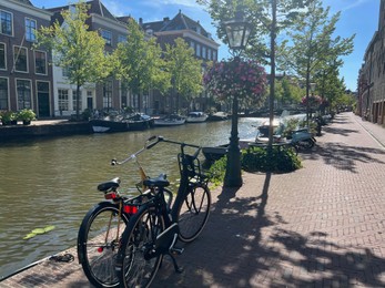 Photo of Leiden, Netherlands - August 03, 2022: View of city street with buildings along canal