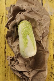 Photo of Fresh ripe Chinese cabbage on yellow wooden table, top view