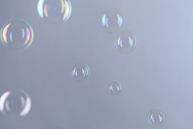 Beautiful transparent soap bubbles on gray background