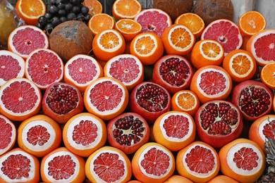 Photo of Pile of different fresh fruits and coconuts at outdoor market