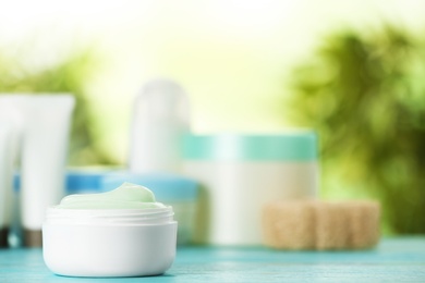 Photo of Jar of body care product on table against blurred background. Space for text