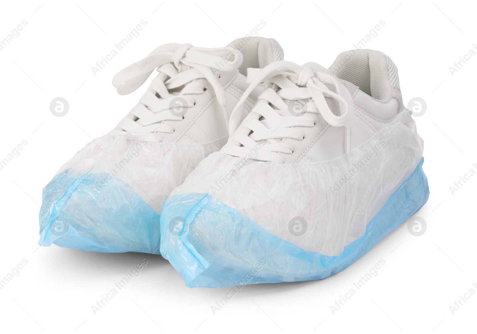 Photo of Sneakers in shoe covers isolated on white