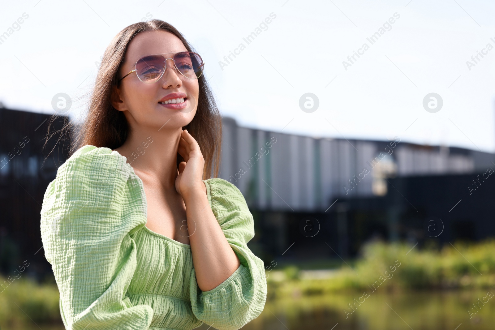 Photo of Beautiful woman in sunglasses outdoors, space for text