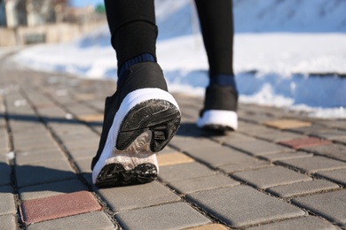 Photo of Man running outdoors on winter day, closeup. Sports exercises