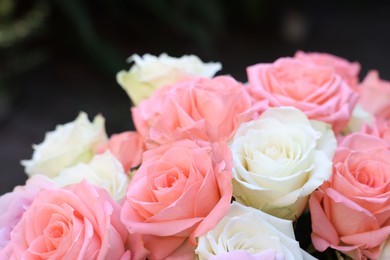 Photo of Beautiful bouquet of aromatic roses outdoors, closeup