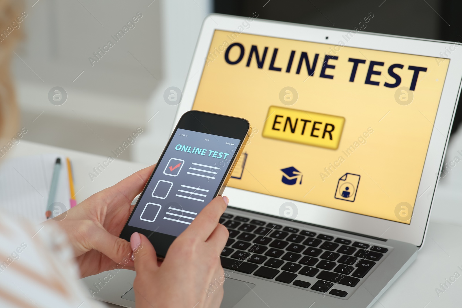 Photo of Woman taking online test on smartphone at desk indoors, closeup