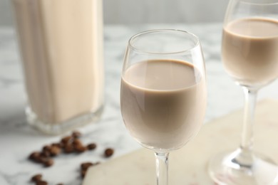 Photo of Coffee cream liqueur in glasses on table, closeup