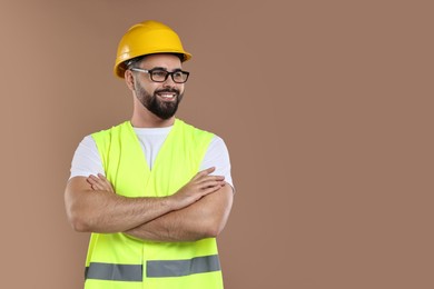 Photo of Engineer in hard hat on brown background