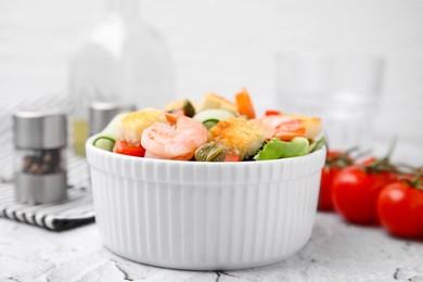 Tasty salad with croutons, tomato and capers on white textured table, closeup