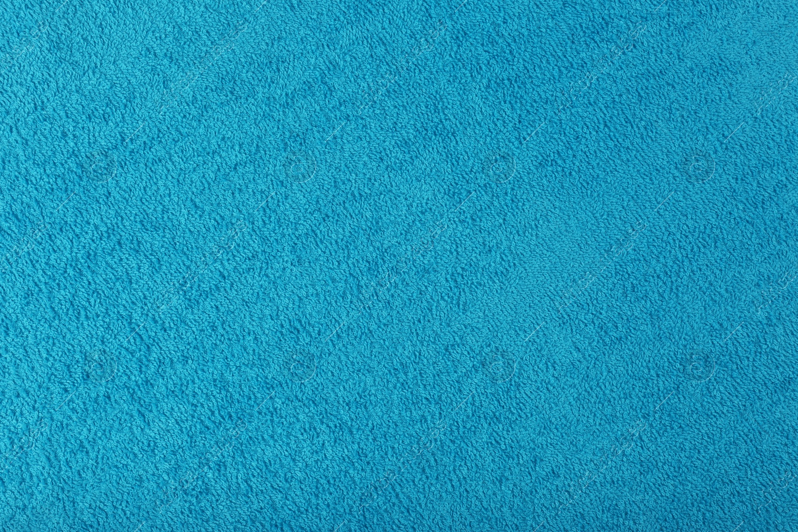 Photo of Clean light blue beach towel as background, closeup