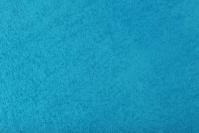 Photo of Clean light blue beach towel as background, closeup