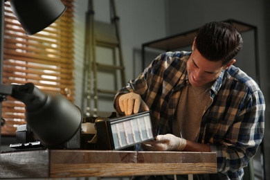 Professional repairman fixing modern printer in office