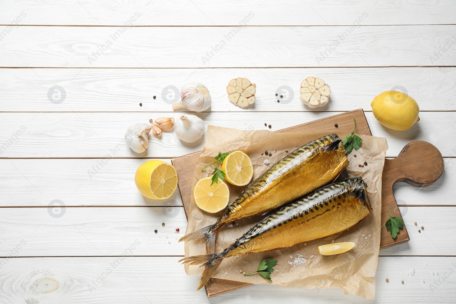Photo of Flat lay composition with tasty smoked fish on white wooden table
