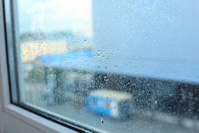 Window glass with water drops, closeup. Condensation