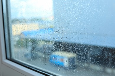 Photo of Window glass with water drops, closeup. Condensation