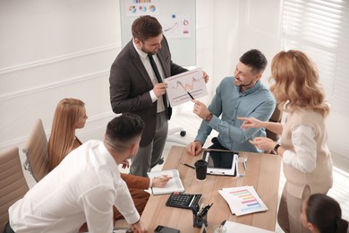 Photo of Businesspeople having meeting in office. Management consulting