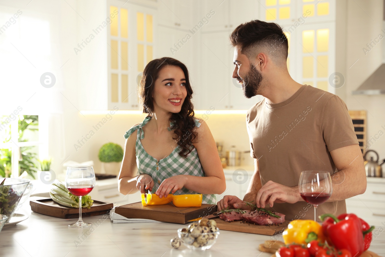 Photo of Lovely young couple cooking together in kitchen