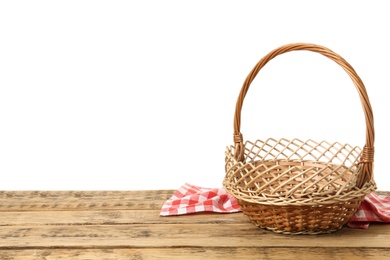 Photo of Wicker basket and towel on wooden table against white background, space for text. Easter item