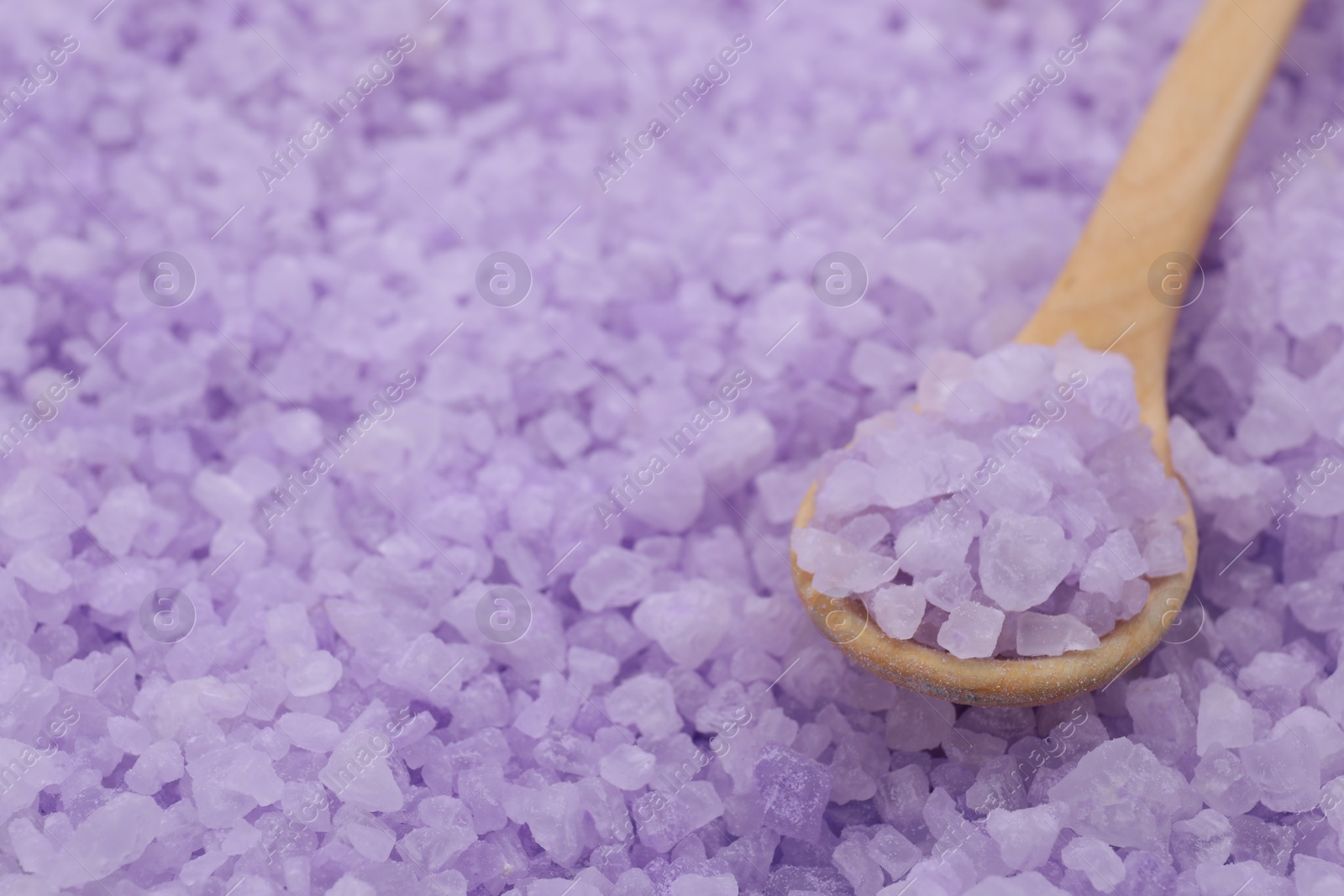 Photo of Spoon with violet sea salt, closeup. Space for text