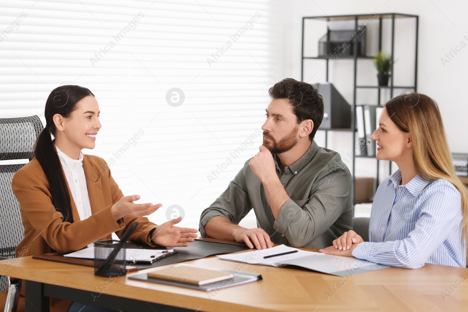 Photo of Couple having meeting with lawyer in office