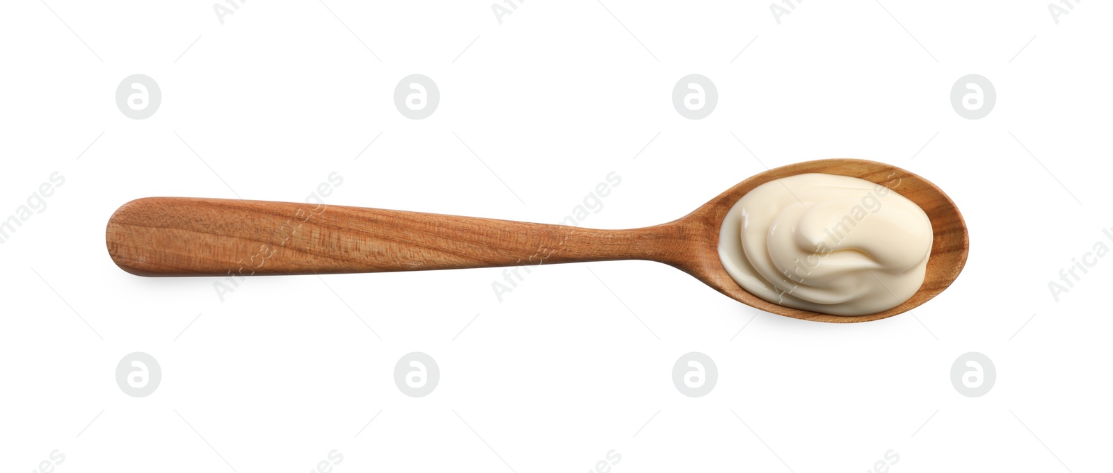 Photo of Natural yogurt in wooden spoon isolated on white, top view