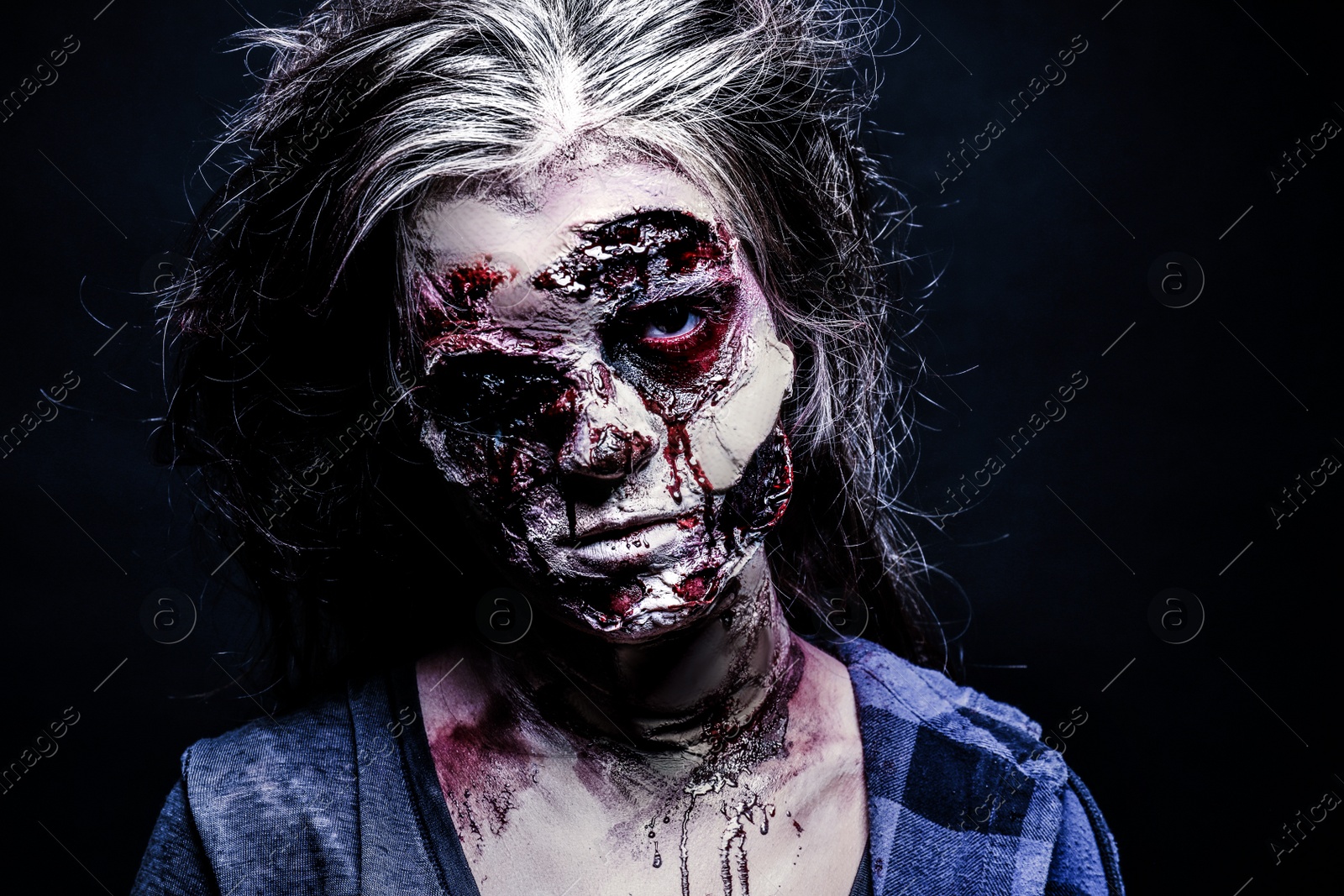 Photo of Scary zombie on dark background. Halloween monster