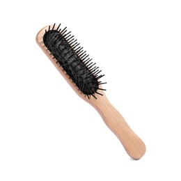 Photo of Wooden brush with lost hair in air on white background