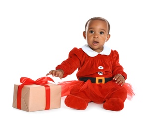 Little African-American baby with Christmas gift on white background