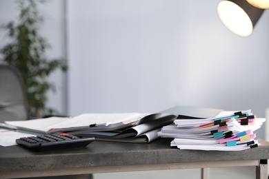 Photo of Folders with documents and calculator on office table. Space for text