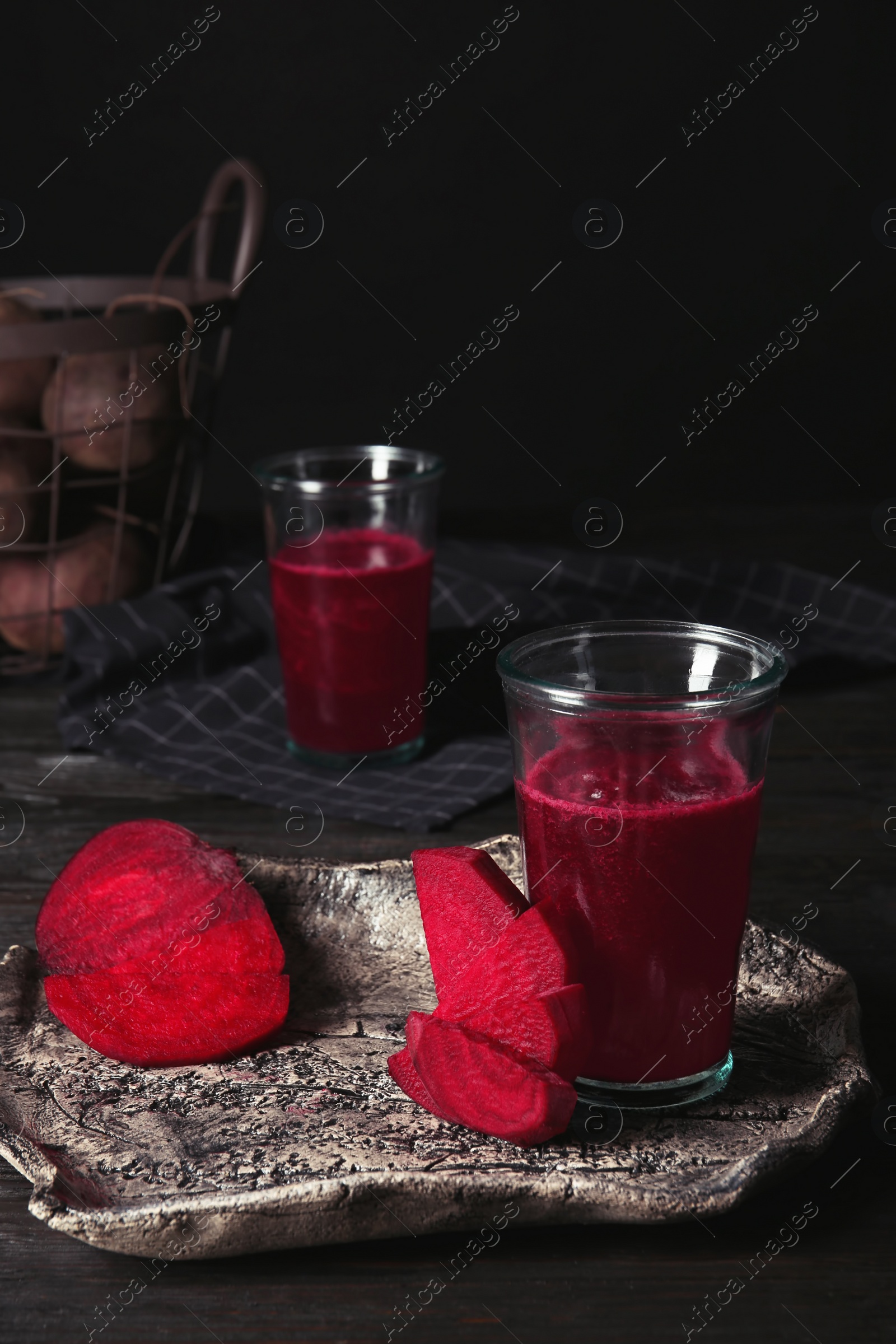 Photo of Plate with glass of beet smoothie on table