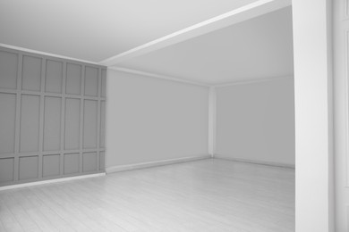 Empty room with grey wall and laminated floor