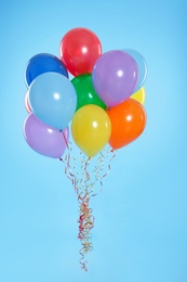 Photo of Bunch of bright balloons on color background