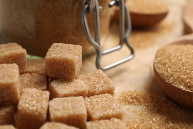 Photo of Refined brown sugar cubes on table, closeup