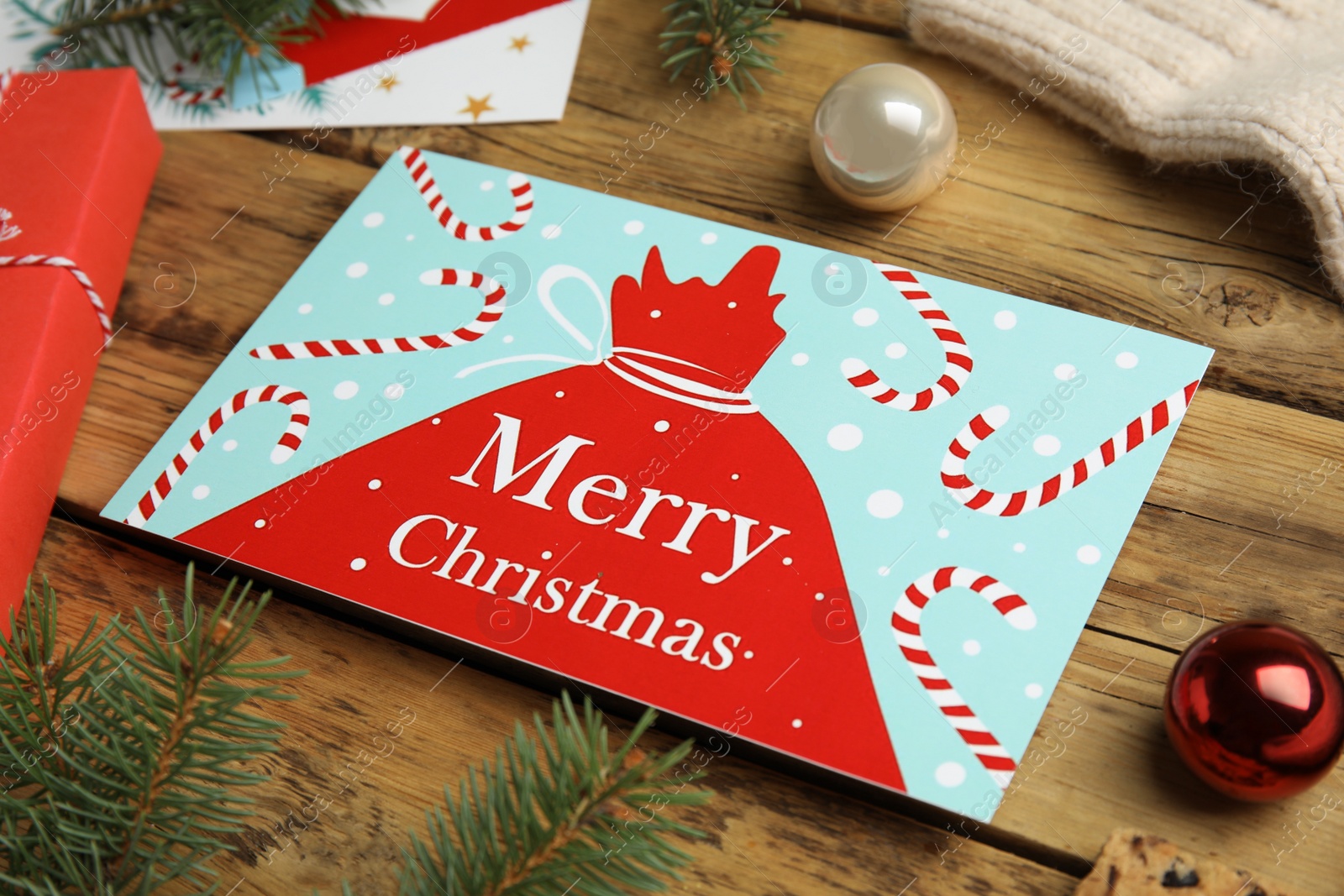 Photo of Christmas card and festive decor on wooden background