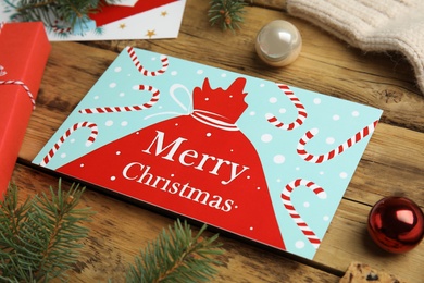 Christmas card and festive decor on wooden background