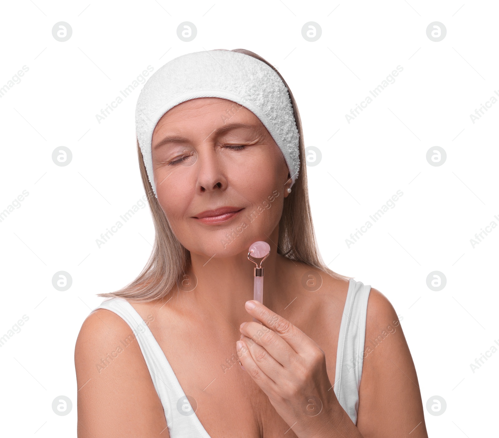 Photo of Woman massaging her face with rose quartz roller isolated on white