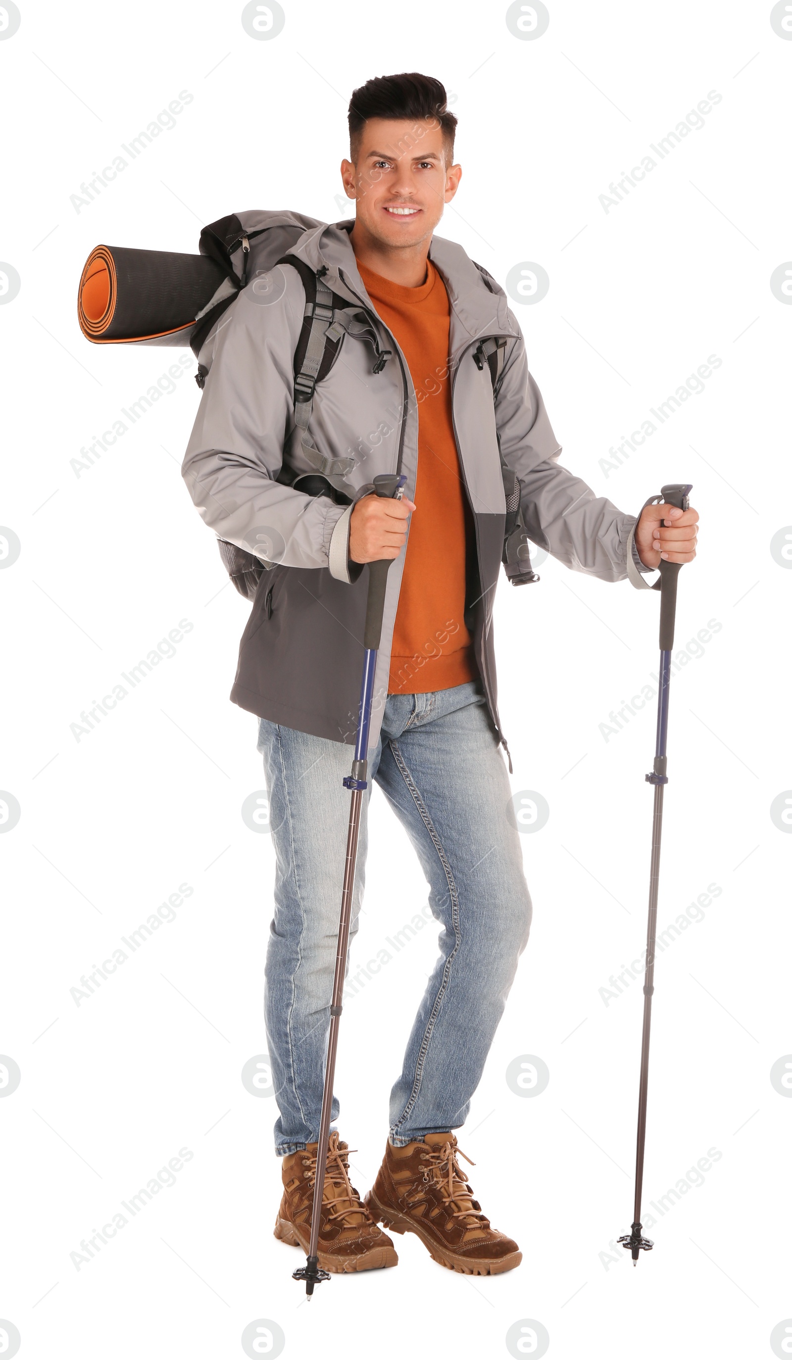 Photo of Male hiker with backpack and trekking poles on white background