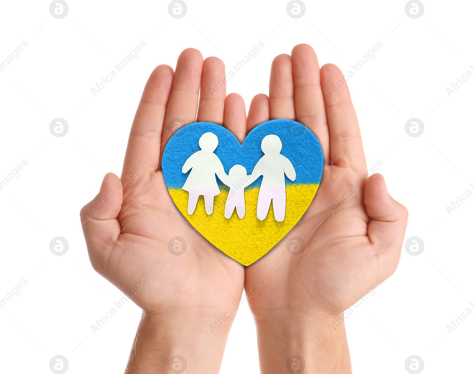 Image of Stop war in Ukraine. Man holding heart with colors of Ukrainian flags and paper family in hands on white background, closeup
