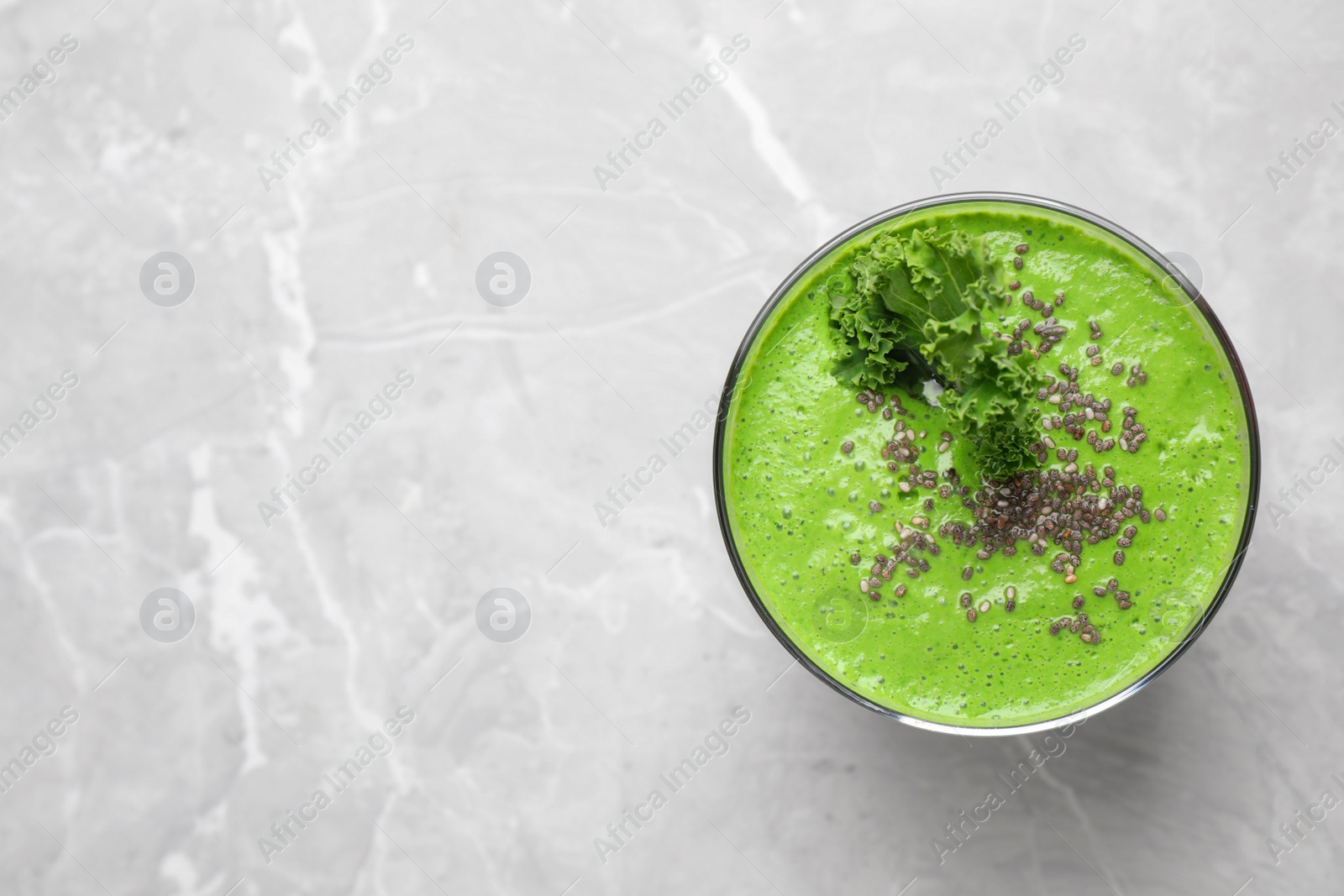 Photo of Tasty kale smoothie with chia seeds on light grey marble table, top view. Space for text