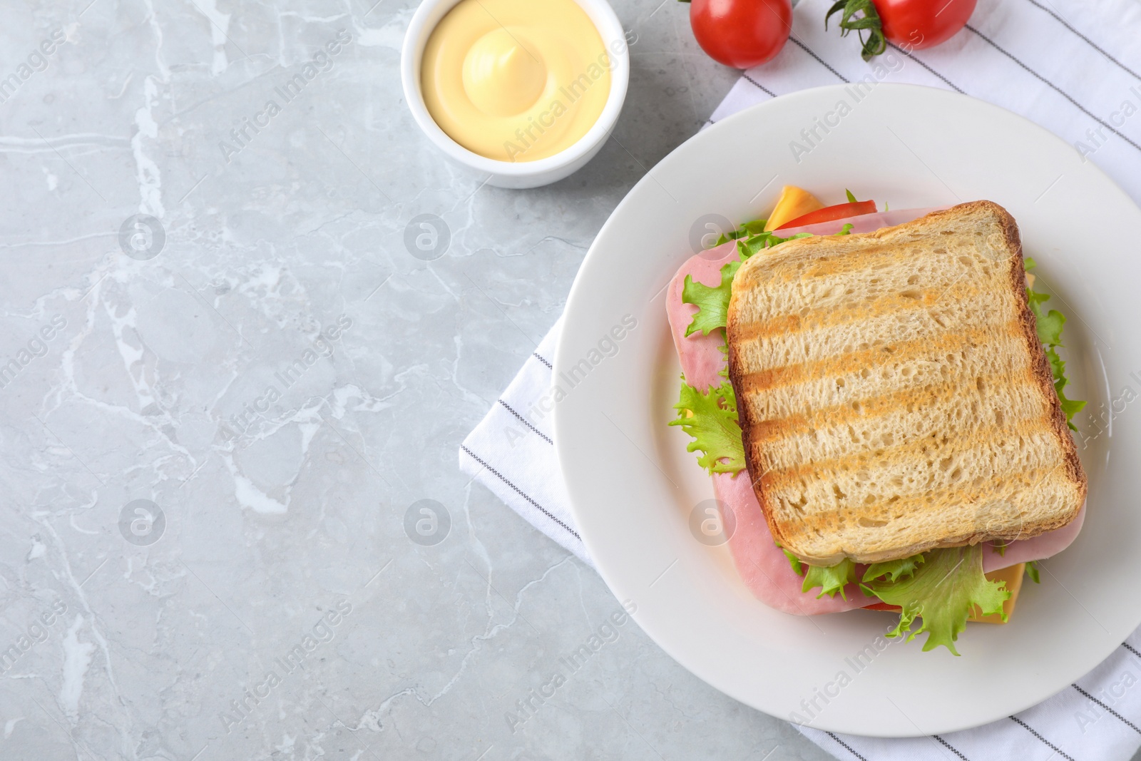 Photo of Tasty sandwich with ham on grey table, flat lay. Space for text