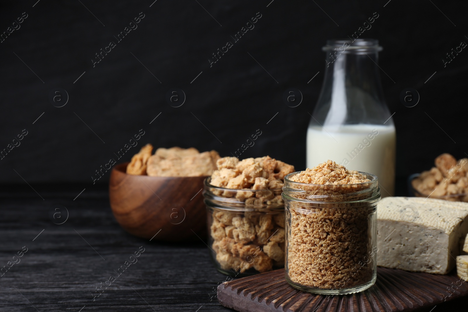 Photo of Different fresh soy products on black wooden table, space for text