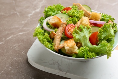 Photo of Delicious fresh chicken salad served on grey table, closeup