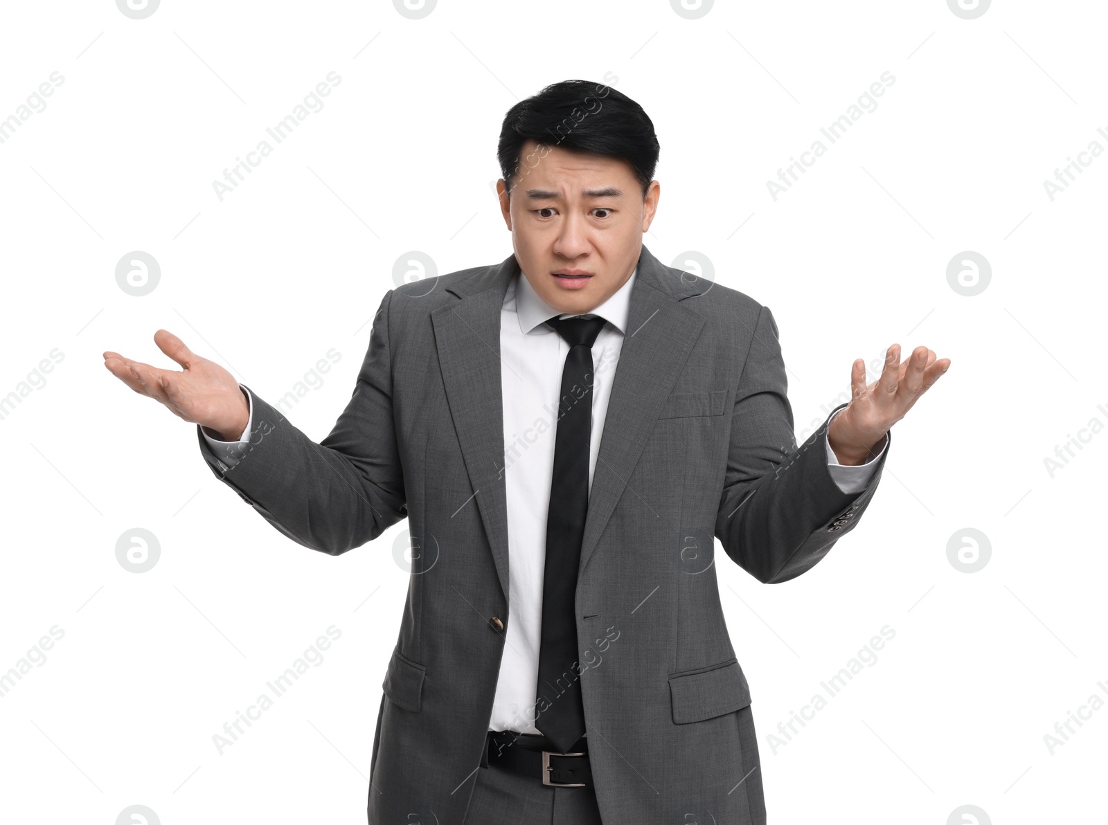 Photo of Confused businessman in suit posing on white background