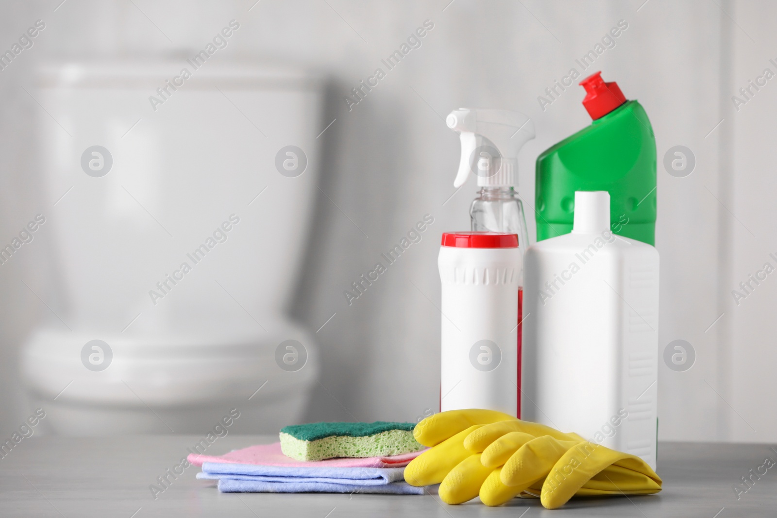 Photo of Different cleaning supplies on table indoors, space for text