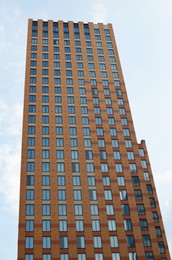 Photo of Beautiful view of modern skyscraper outdoors on sunny day