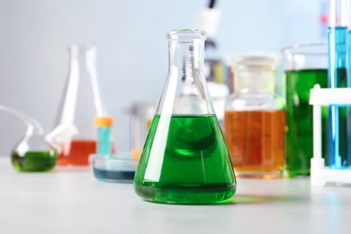 Photo of Conical flask and other glassware on table in chemistry laboratory