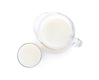 Photo of Jug and glass with fresh milk on white background, top view