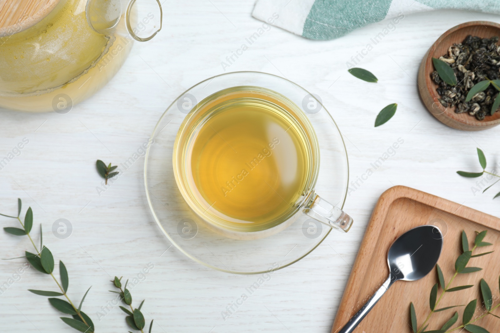 Photo of Aromatic eucalyptus tea on white wooden table, flat lay