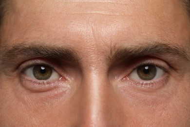Photo of Man with beautiful hazel eyes as background, closeup