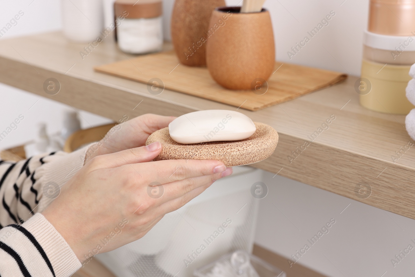 Photo of Bath accessories. Woman with soap indoors, closeup